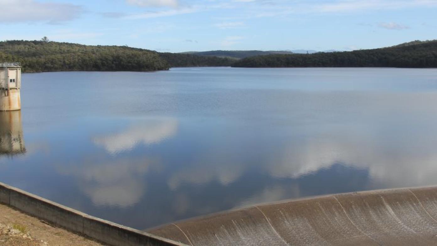 Large body of water surrounded by bushland.