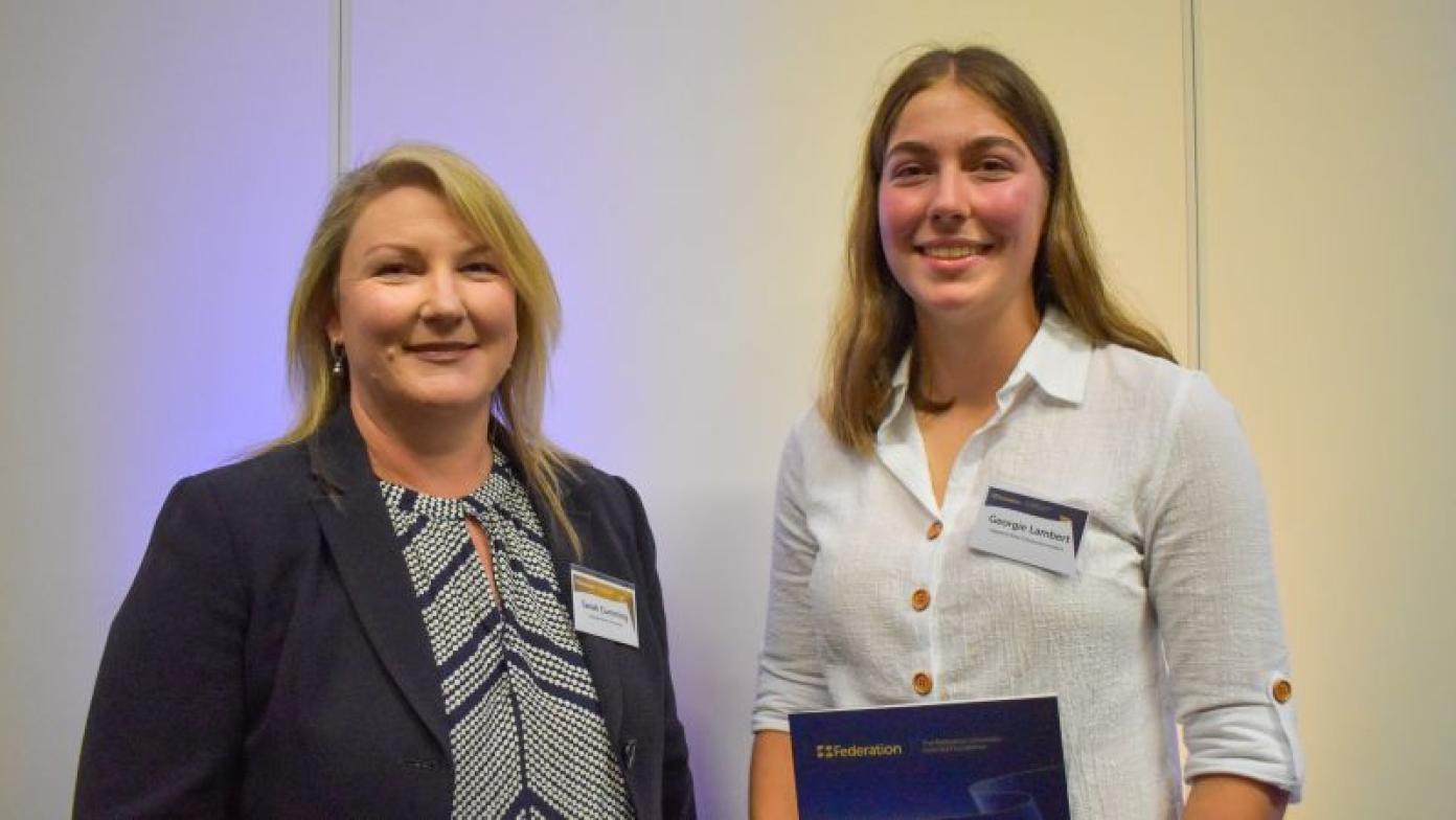 Sarah Cumming and Georgie Lambert stand together smiling. 