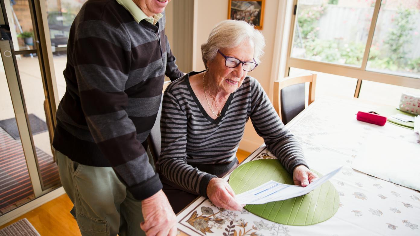 Man and woman read water bill. 