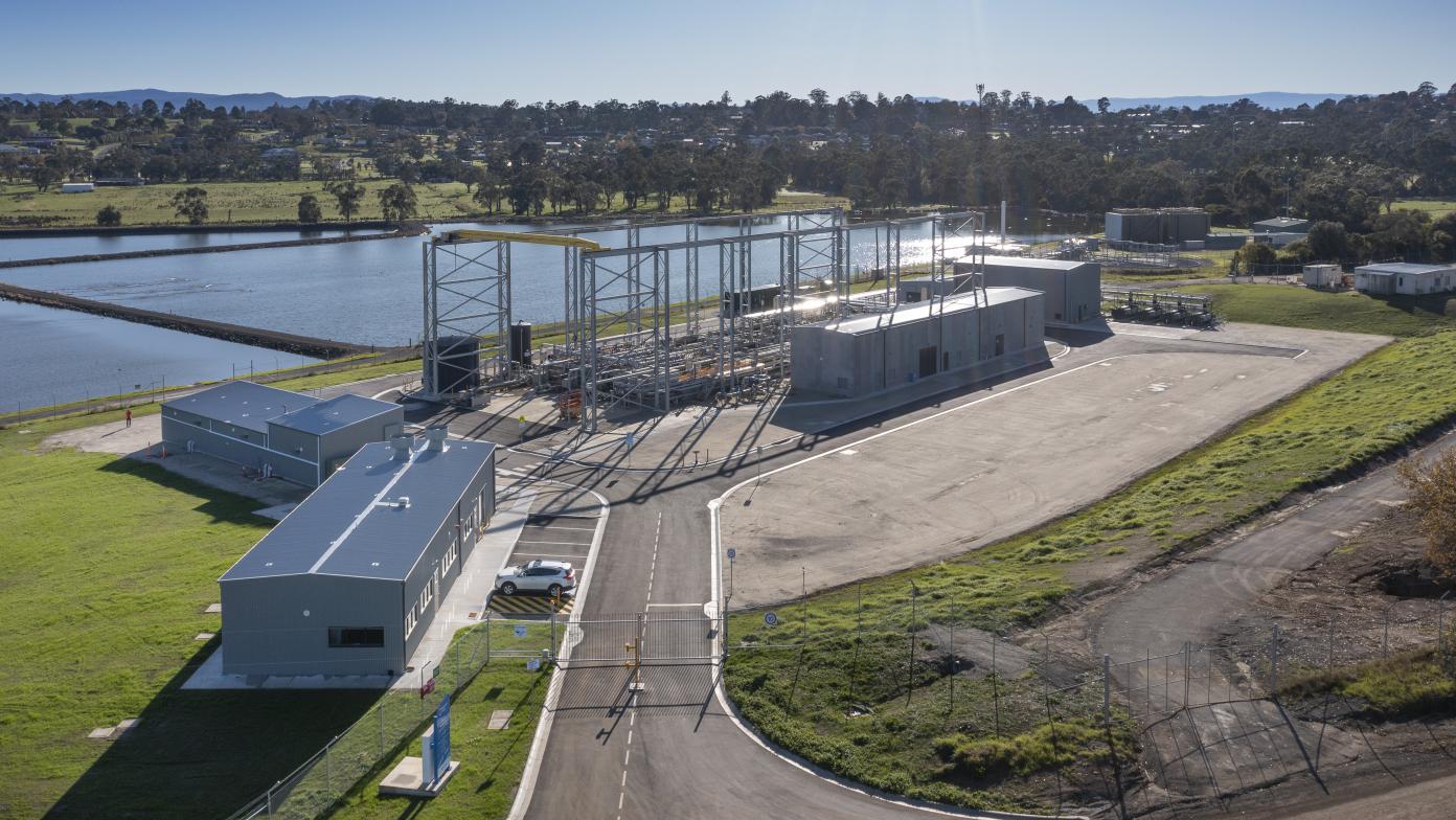 Drone image of Drouin water treatment plant. Grey buildings next to water.