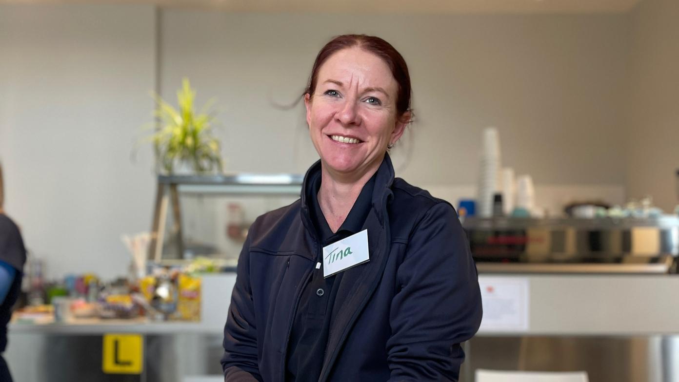 Woman in Gippsland Water uniform smiles.