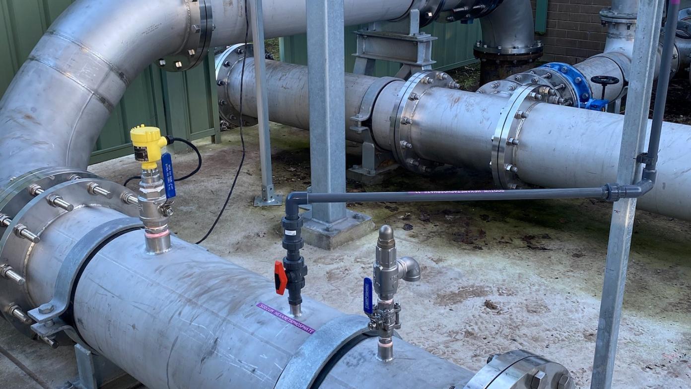 Pipes on top of concrete flooring. 