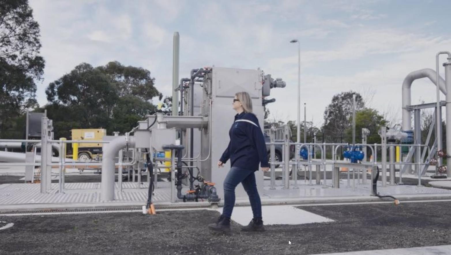 Woman walks through new pump station.