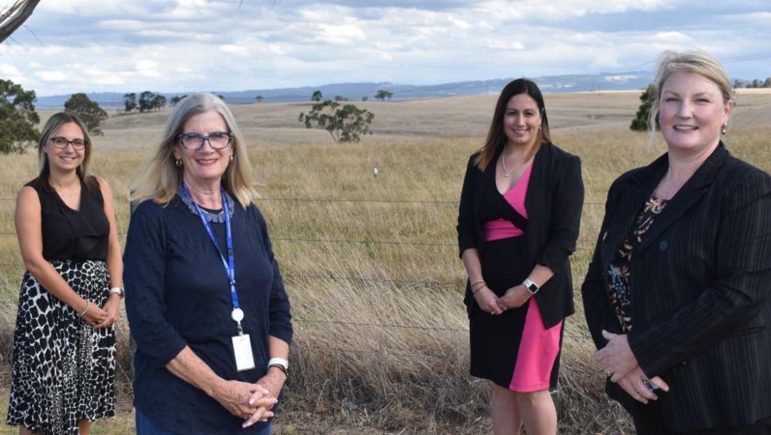 Four women stand in field. One is managing director of Gippsland Water Sarah Cumming.