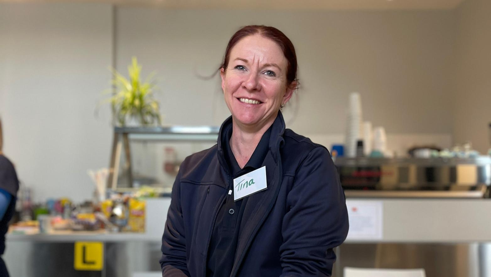 Woman in Gippsland Water uniform smiles.