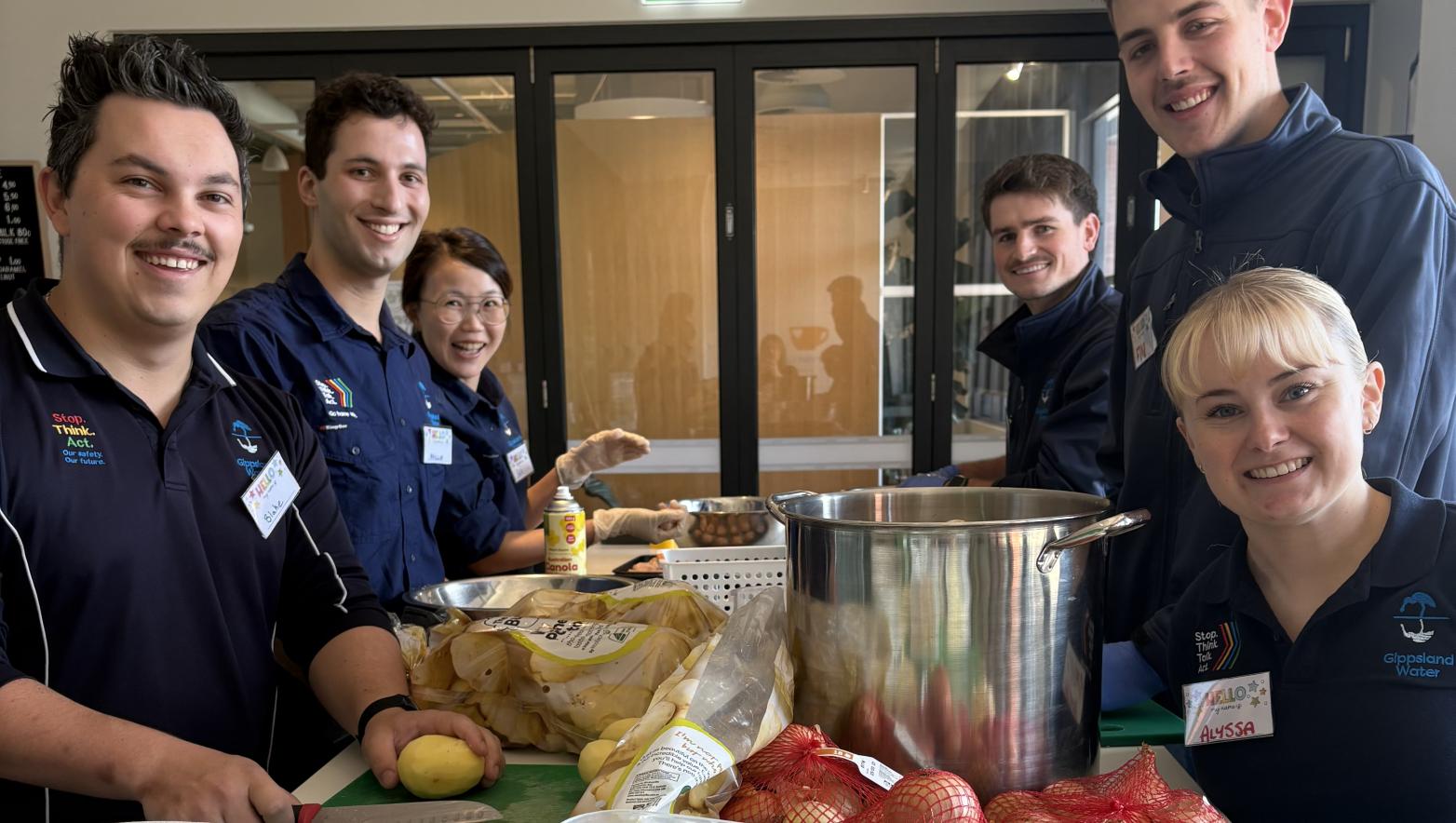 Group of people chopping up vegetables